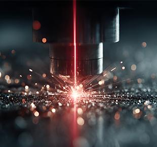 What is the role of laser cutting machines in automobile manufacturing?